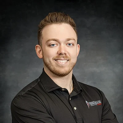 Tyler Loposser Smiling In Front Of Grey Background