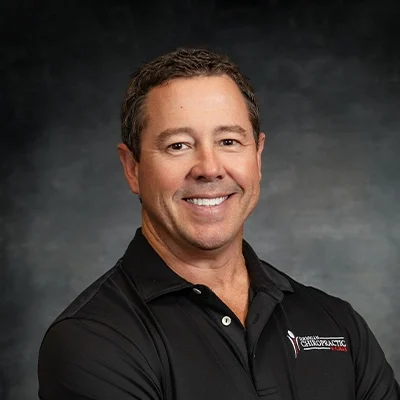 Jeremy Jernigan Smiling In Front Of Grey Background